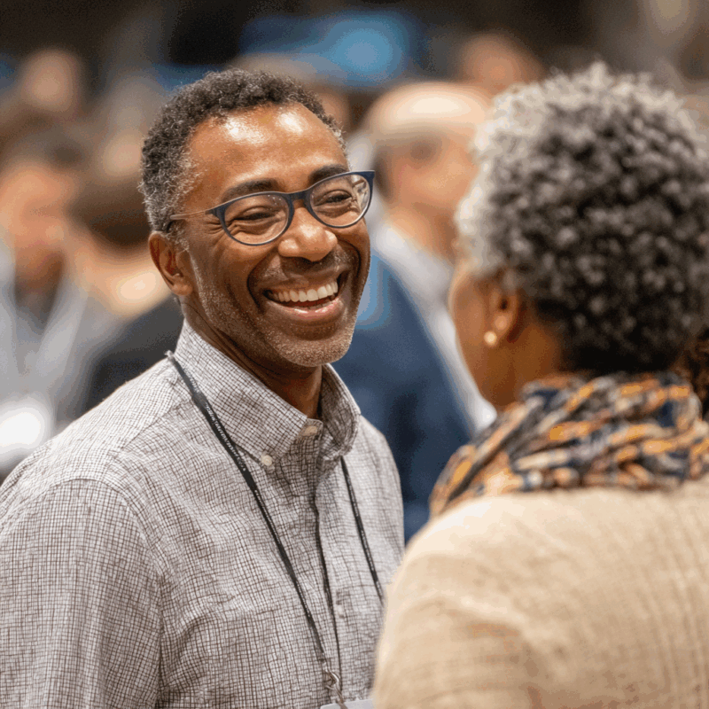 Smiling professional in conversation at an event